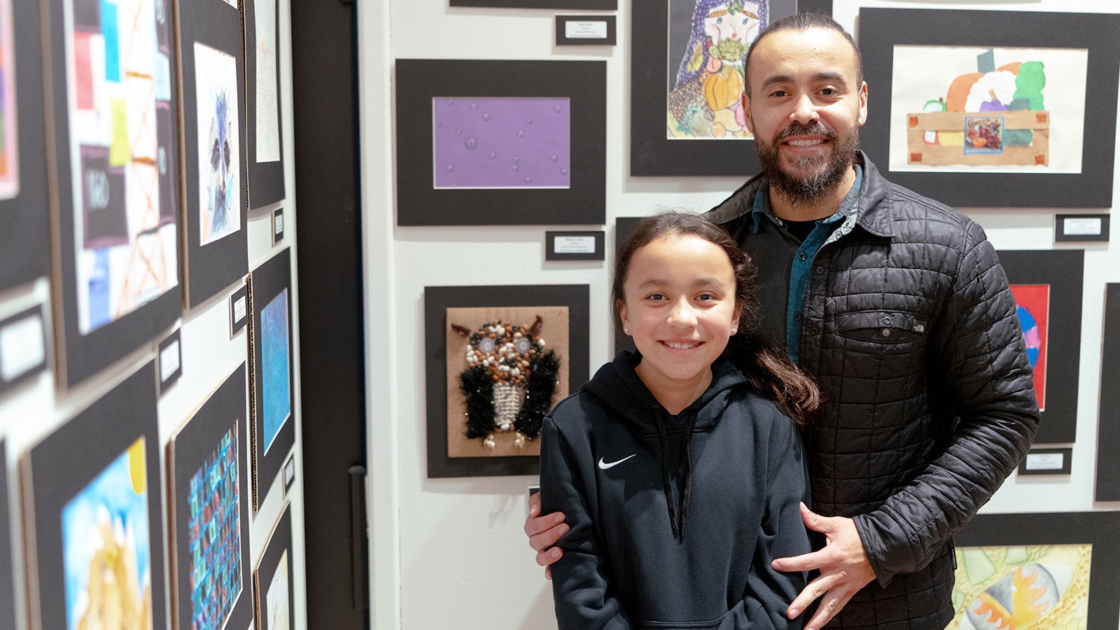 People posing by an art exhibit.