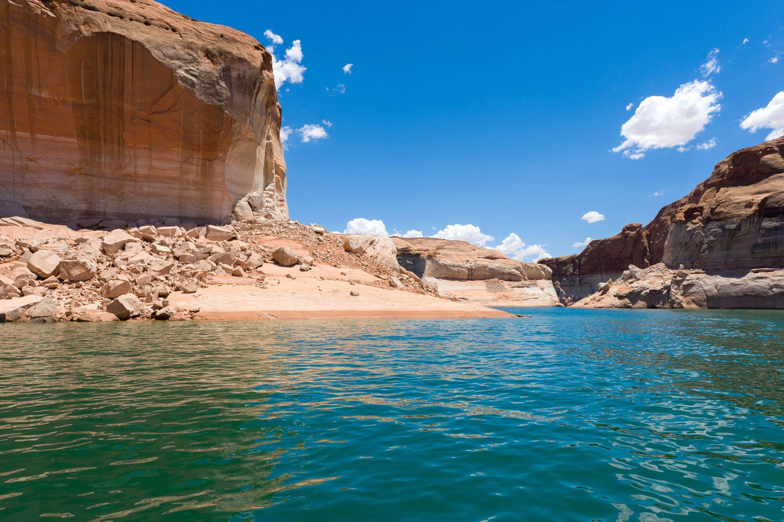 A lake in a red rock desert.