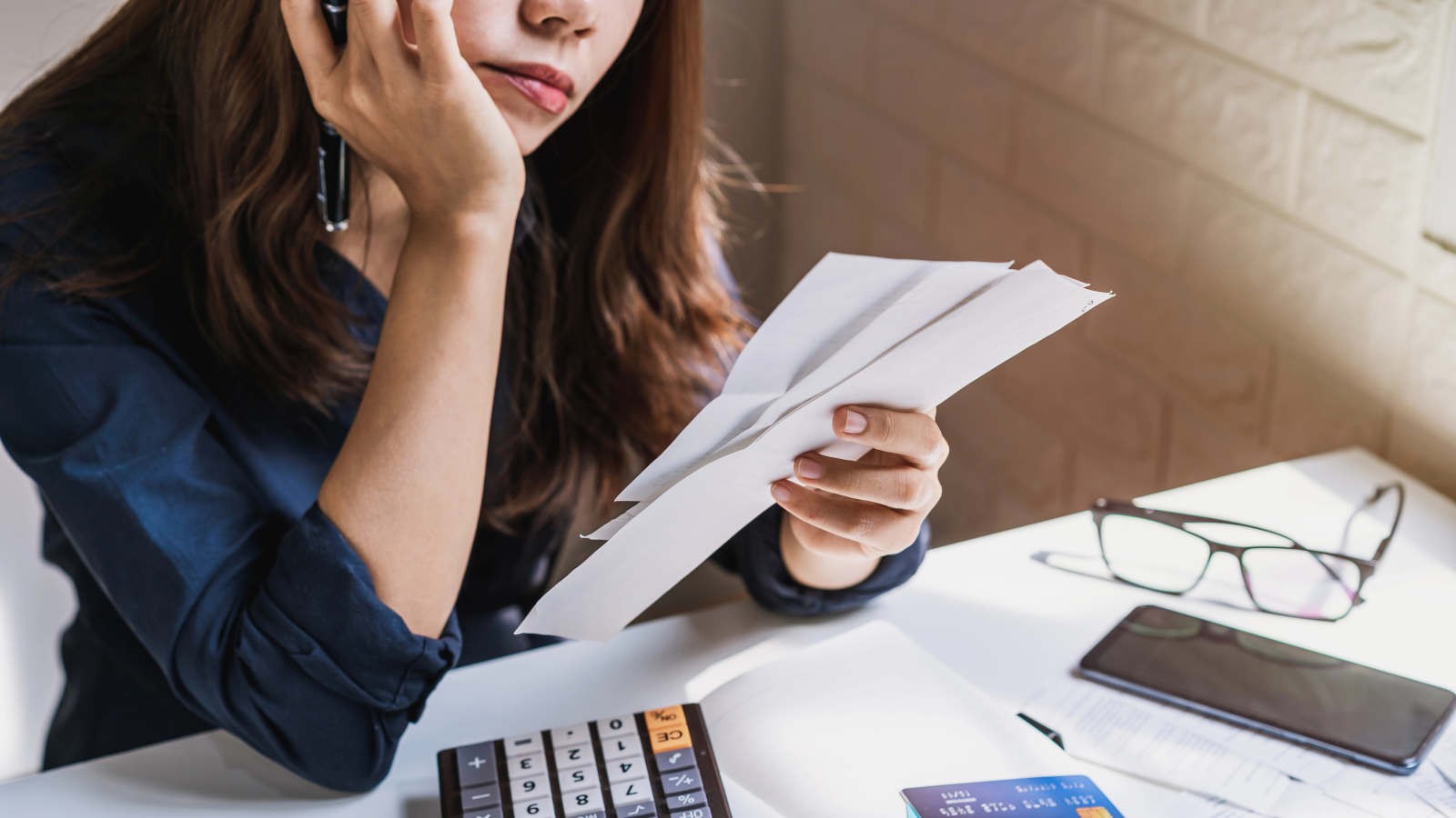 A person looking at bills.