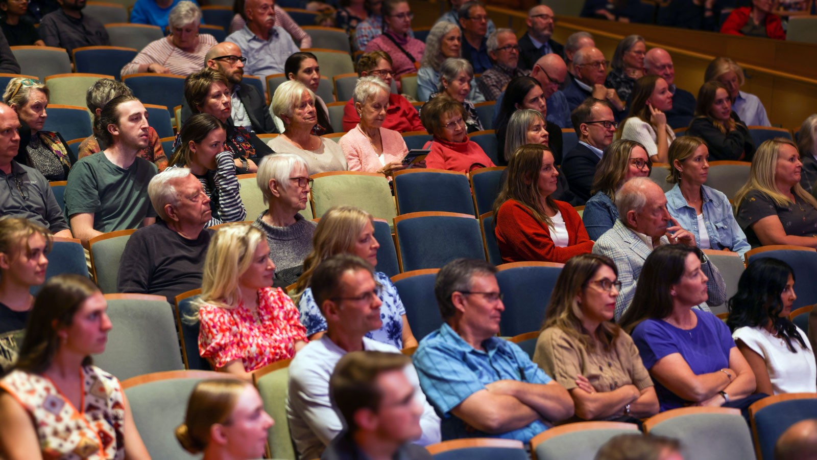 People seated in theater chairs.