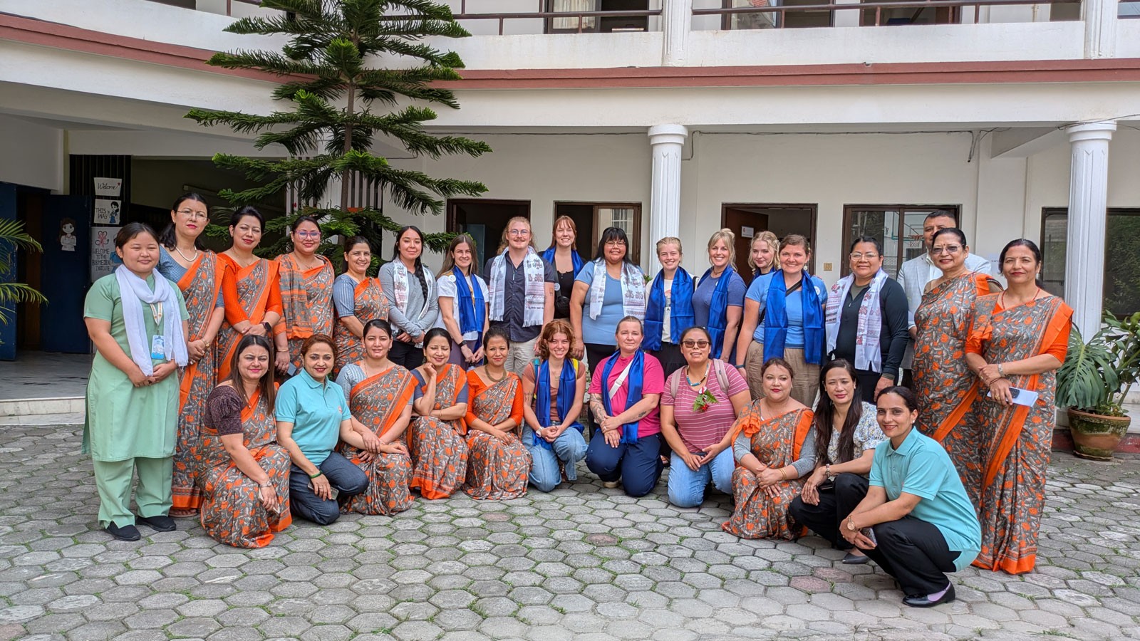 A group photo of healthcare workers, educators and students in Nepal.