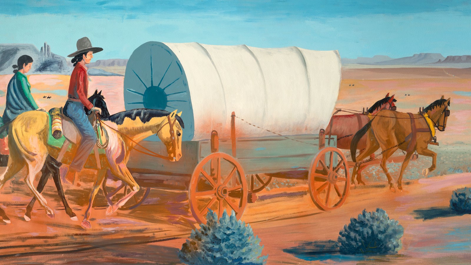A mural of a covered wagon and Native American horseback riders.
