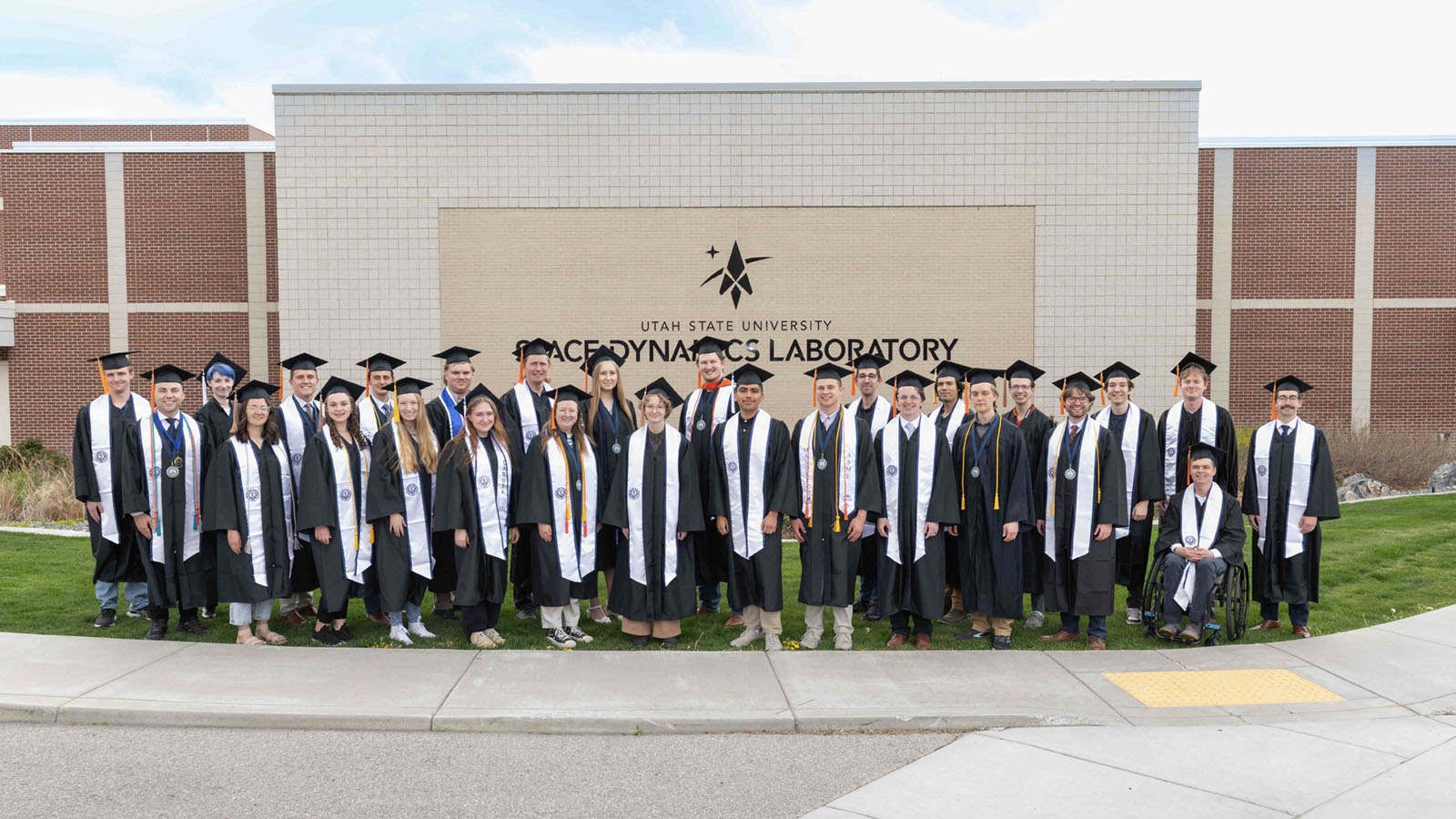 People in graduation robes posing for a group photo.