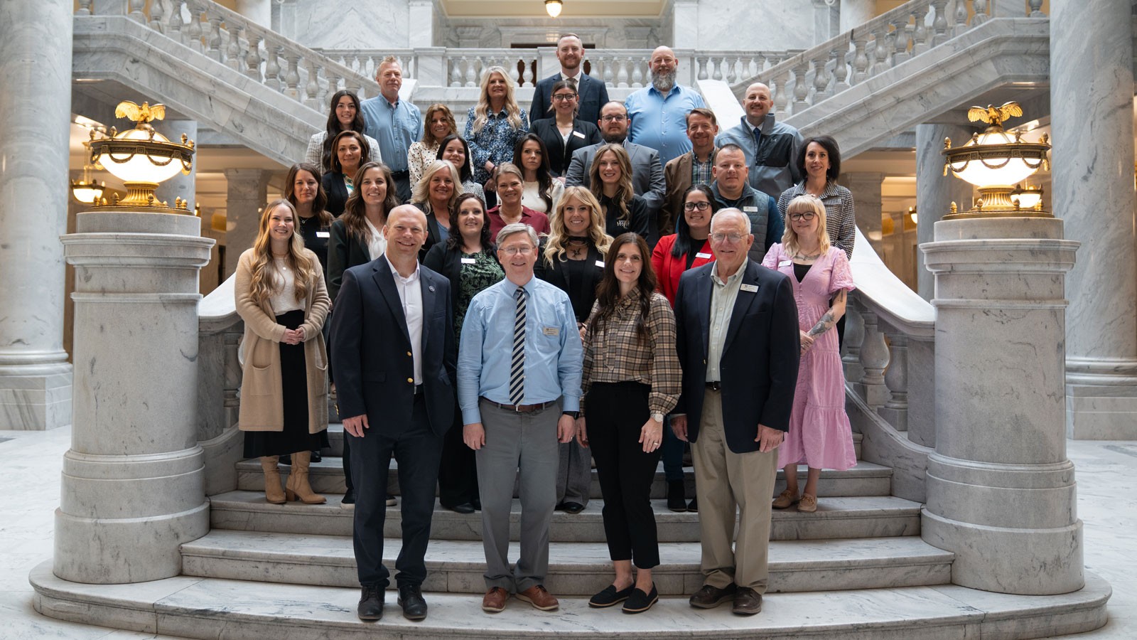 A group posing for a photo inside the Utah State Capitol.