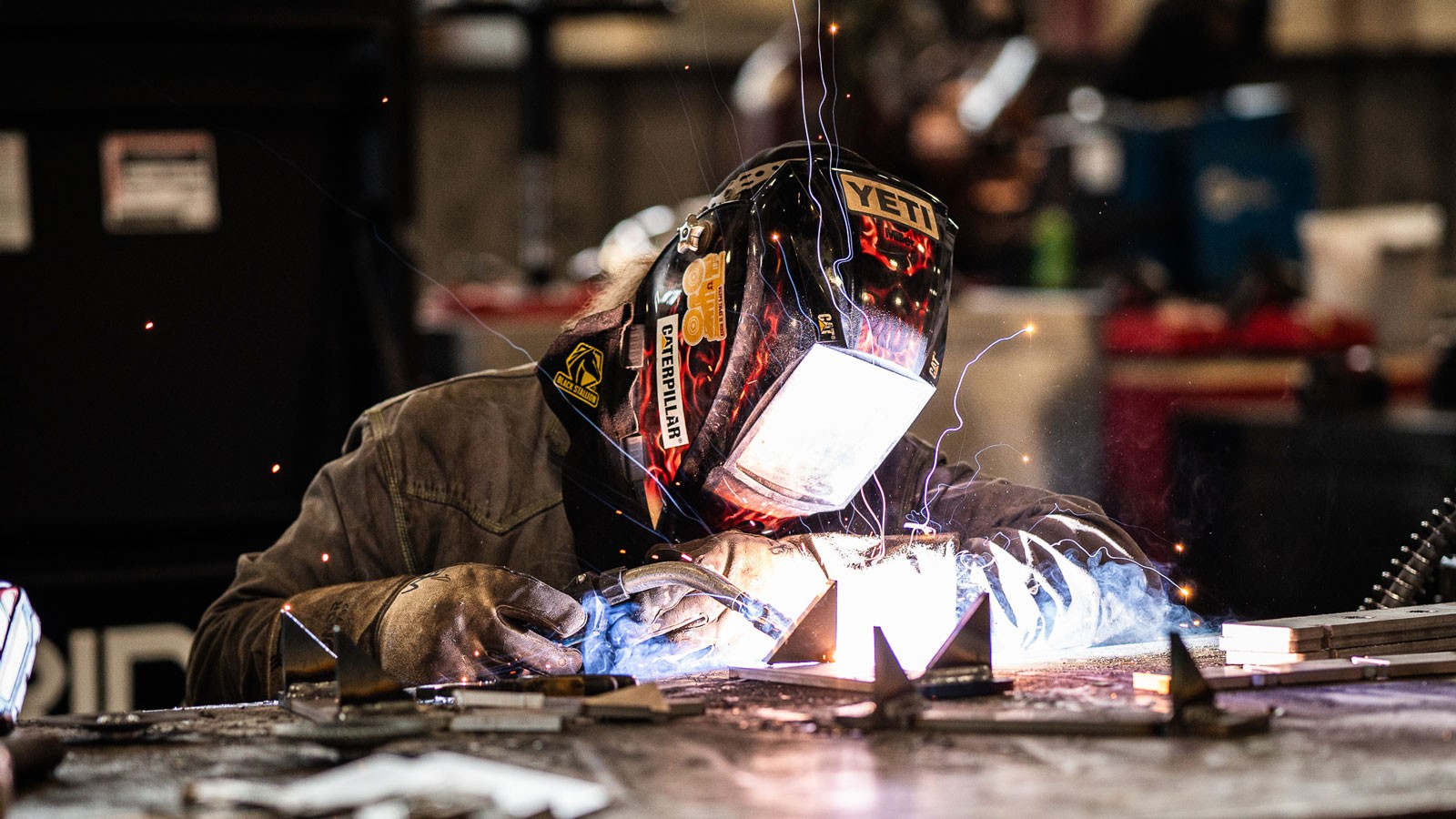 A person in a mask welding.