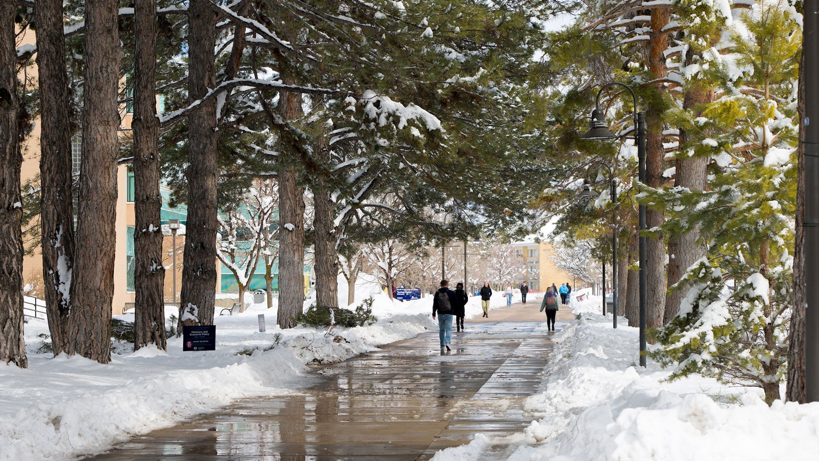 Students walking on a snowy USU Logan campus.
