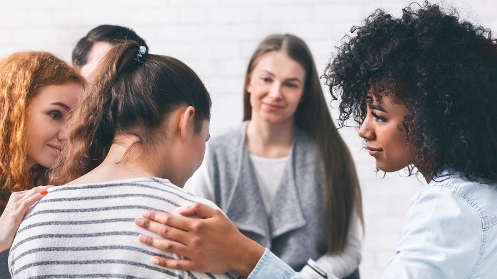 A circle of women speaking with each other.