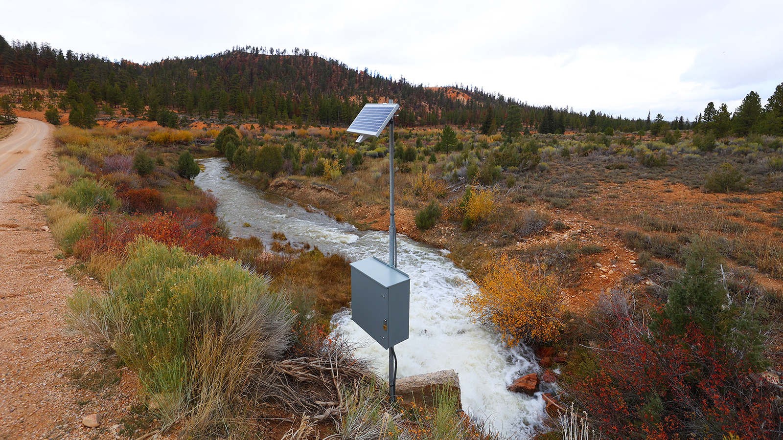 A water gage on a creek in a hilly area.