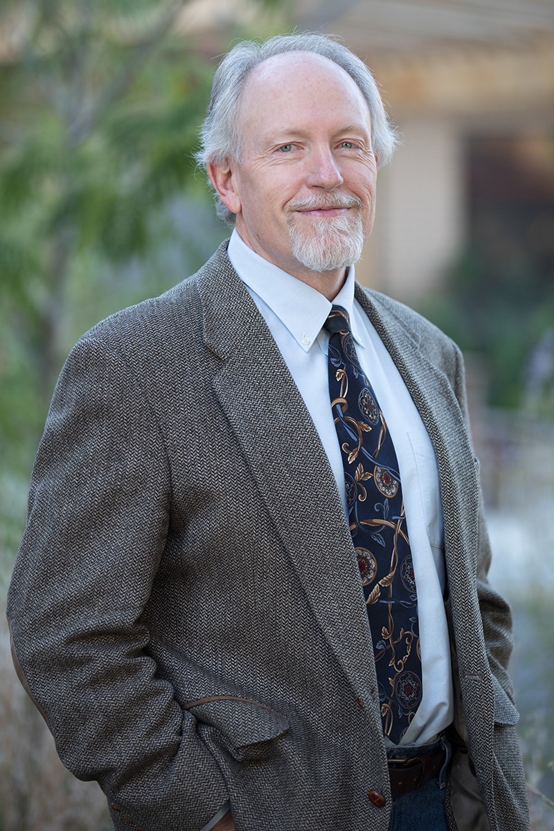 A man poses for a headshot.