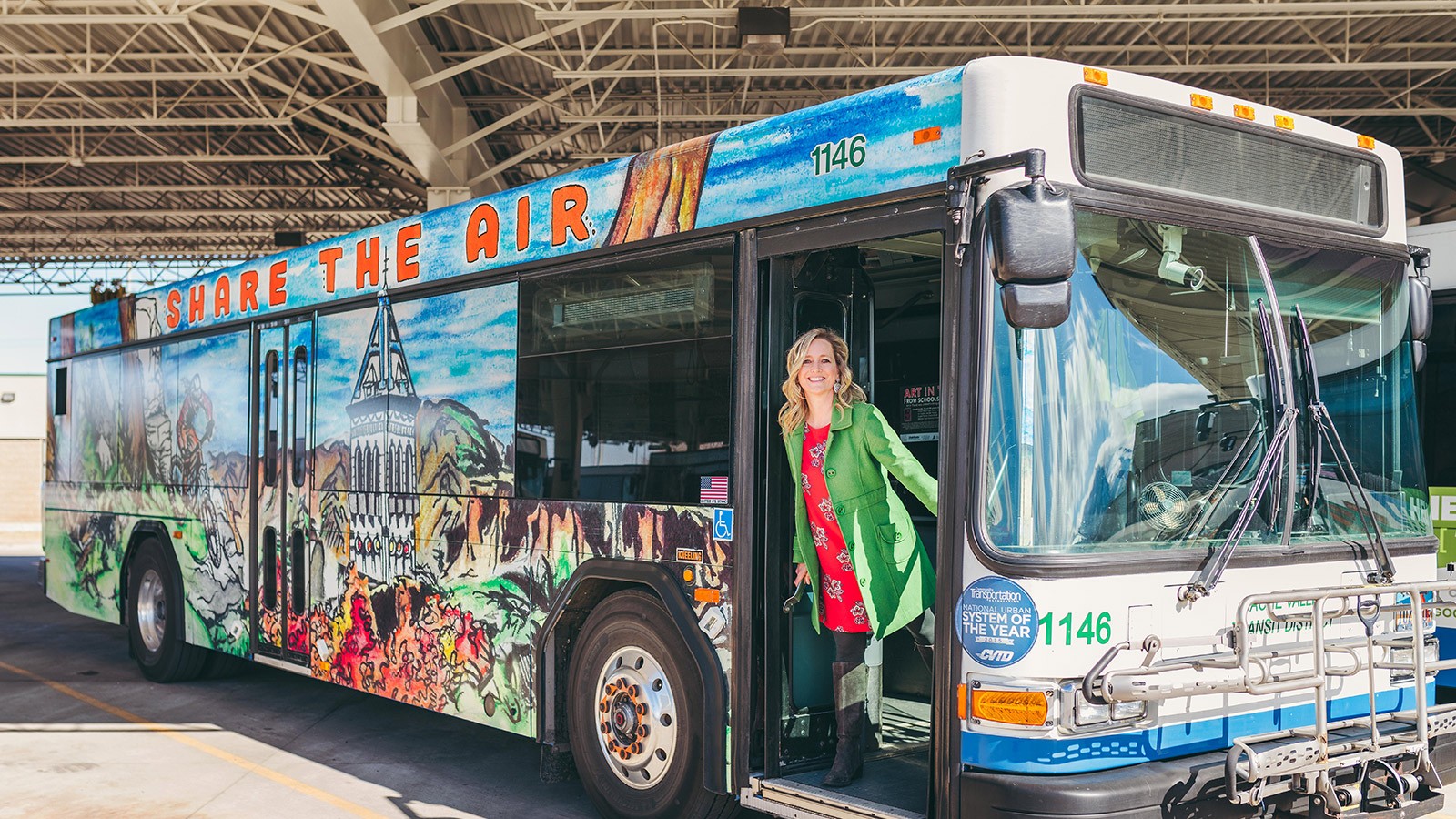 Hughes Villa standing next to an Art in Transit bus.