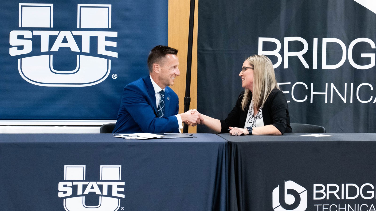 Officials shaking hands at an MOU signing.