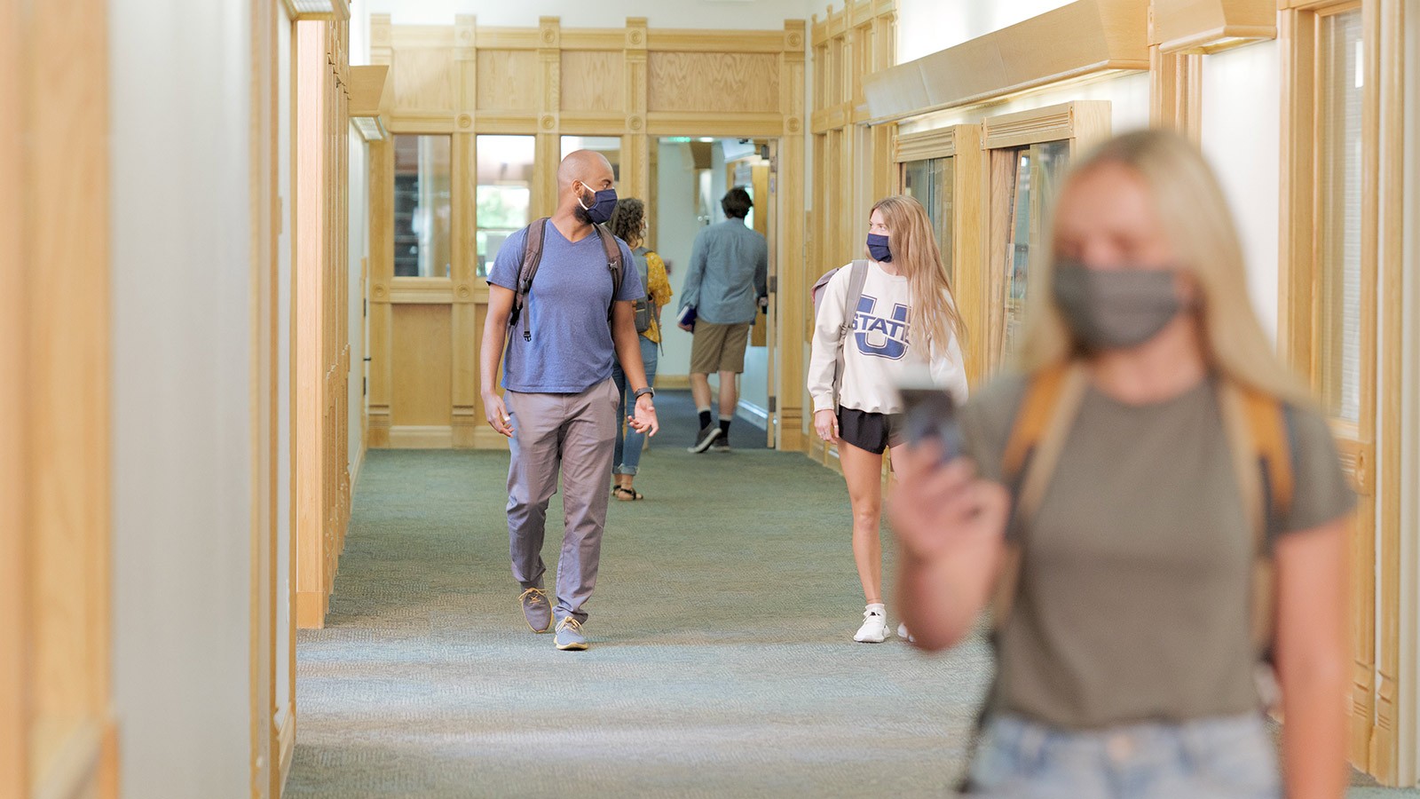 Students walking down a hall in Old Main.