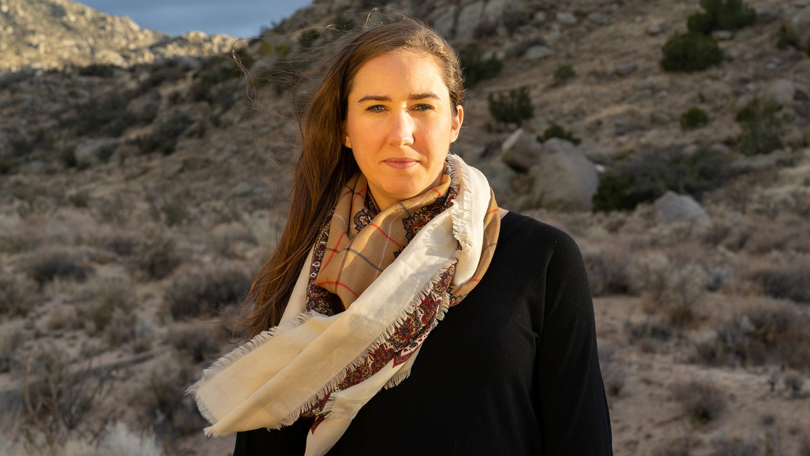 A photo of Evey Gannaway Dalton at the basin of a mountain.
