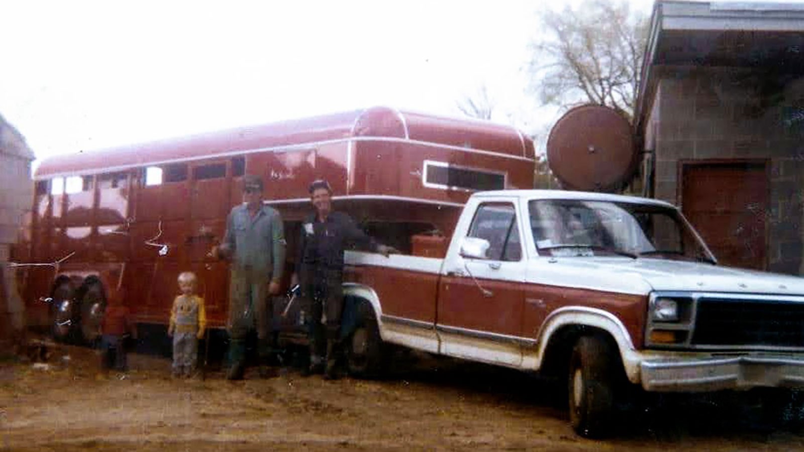 A very young Earl learning to work the family farm with his father and grandfather.