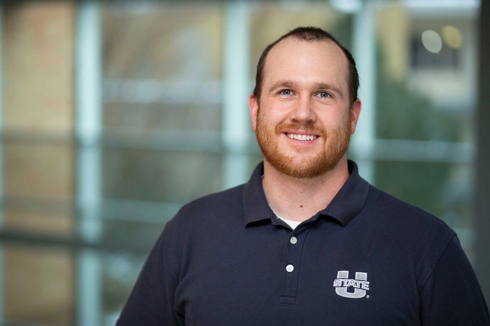 Jack Elliot poses for a photograph in a U State polo shirt.