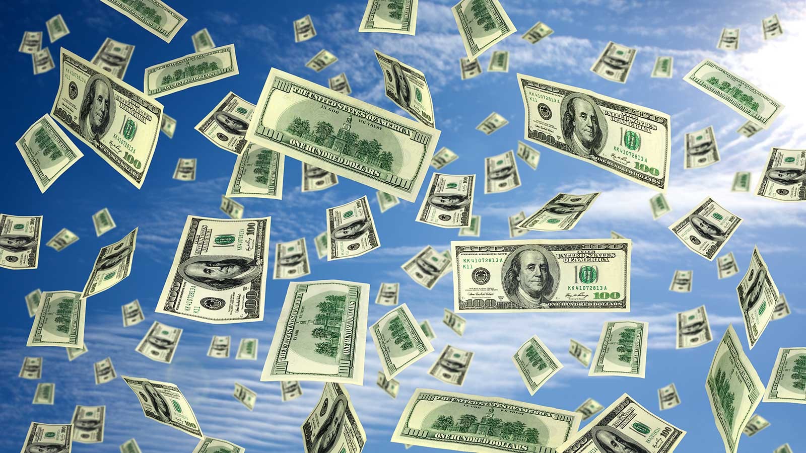 hundred dollar bills flying through the air.
