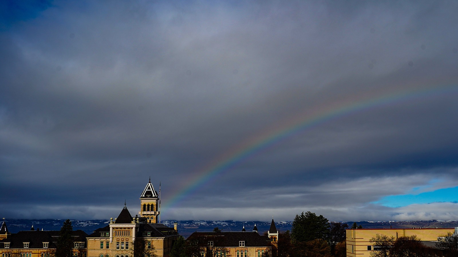 Old Main with a rainbow in the backround.