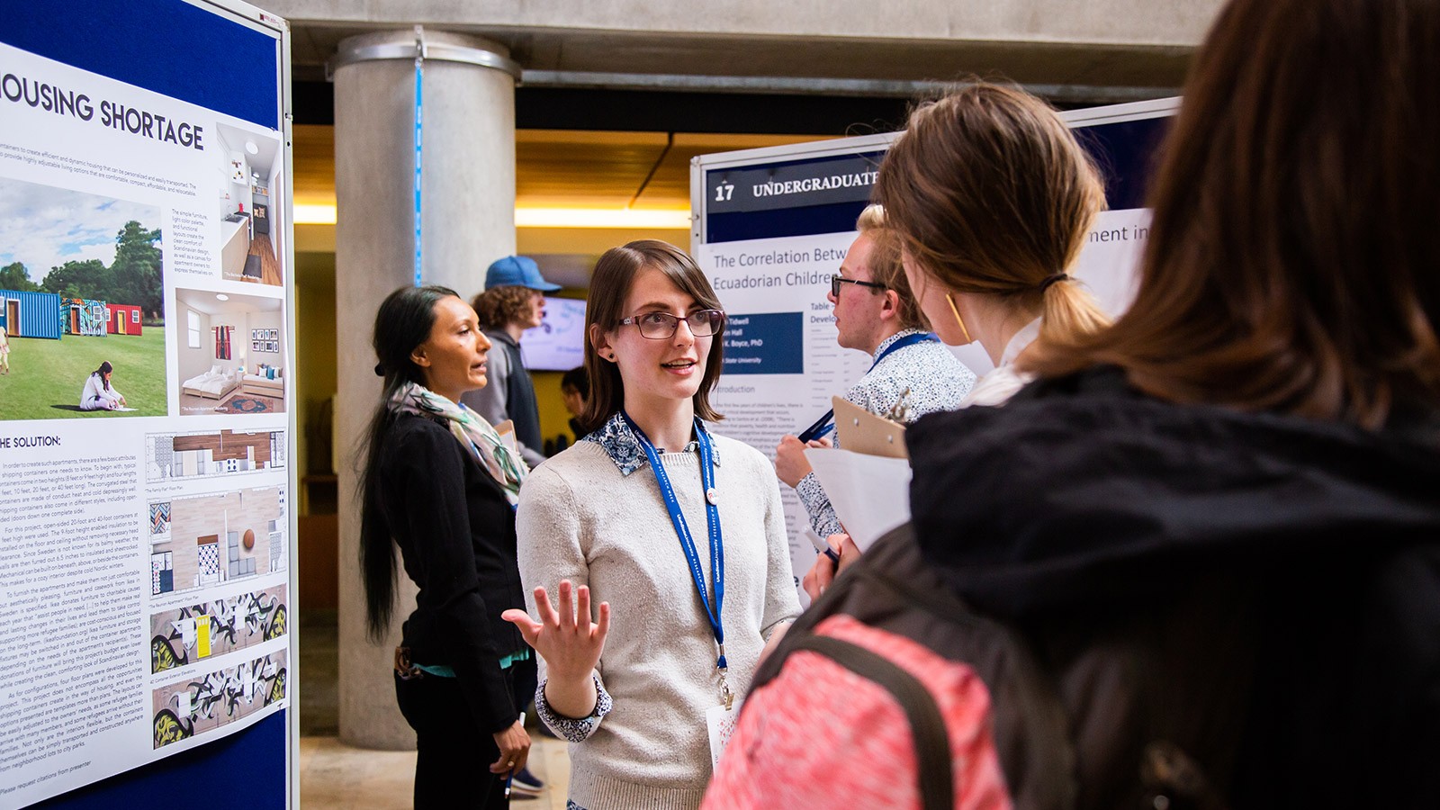 student presenting research at an event.