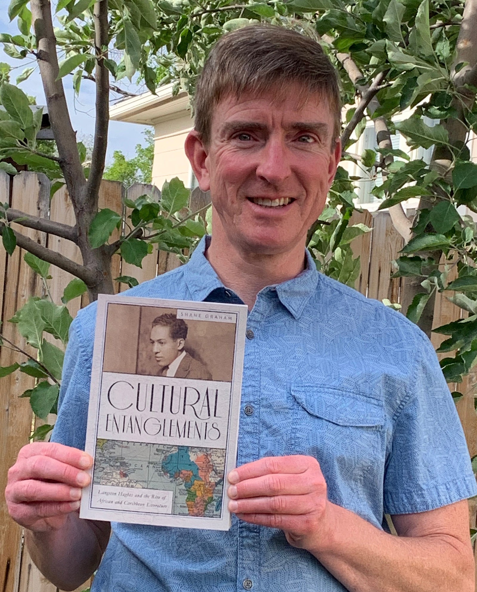English Professor Shane Graham holds his published book.