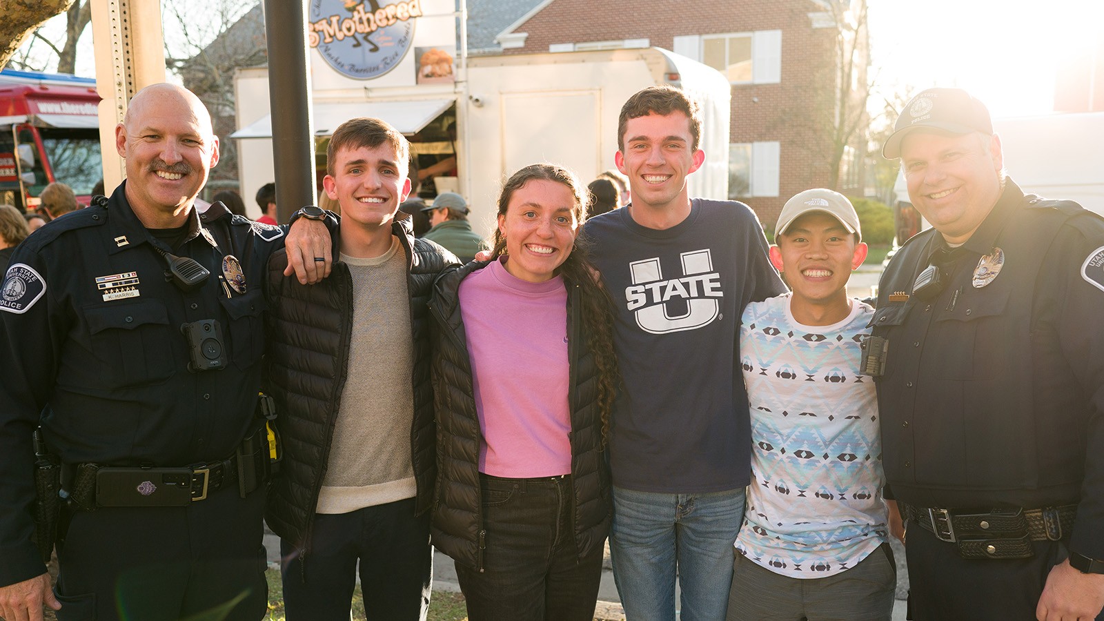 Students pose for a picture with USUPD officers