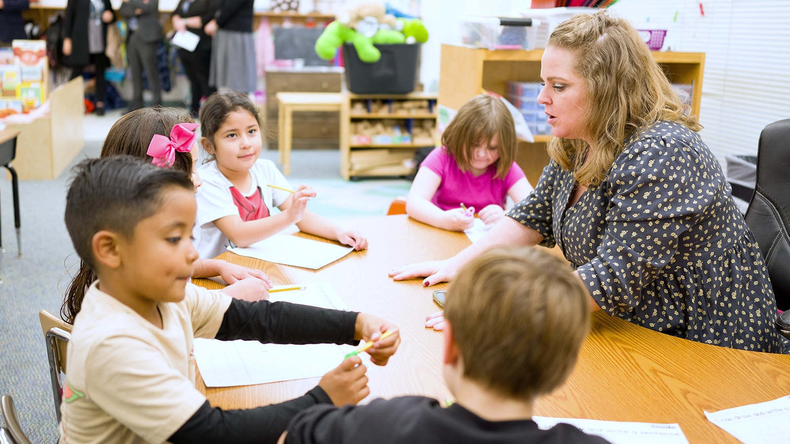 A teacher and students in a classroom.