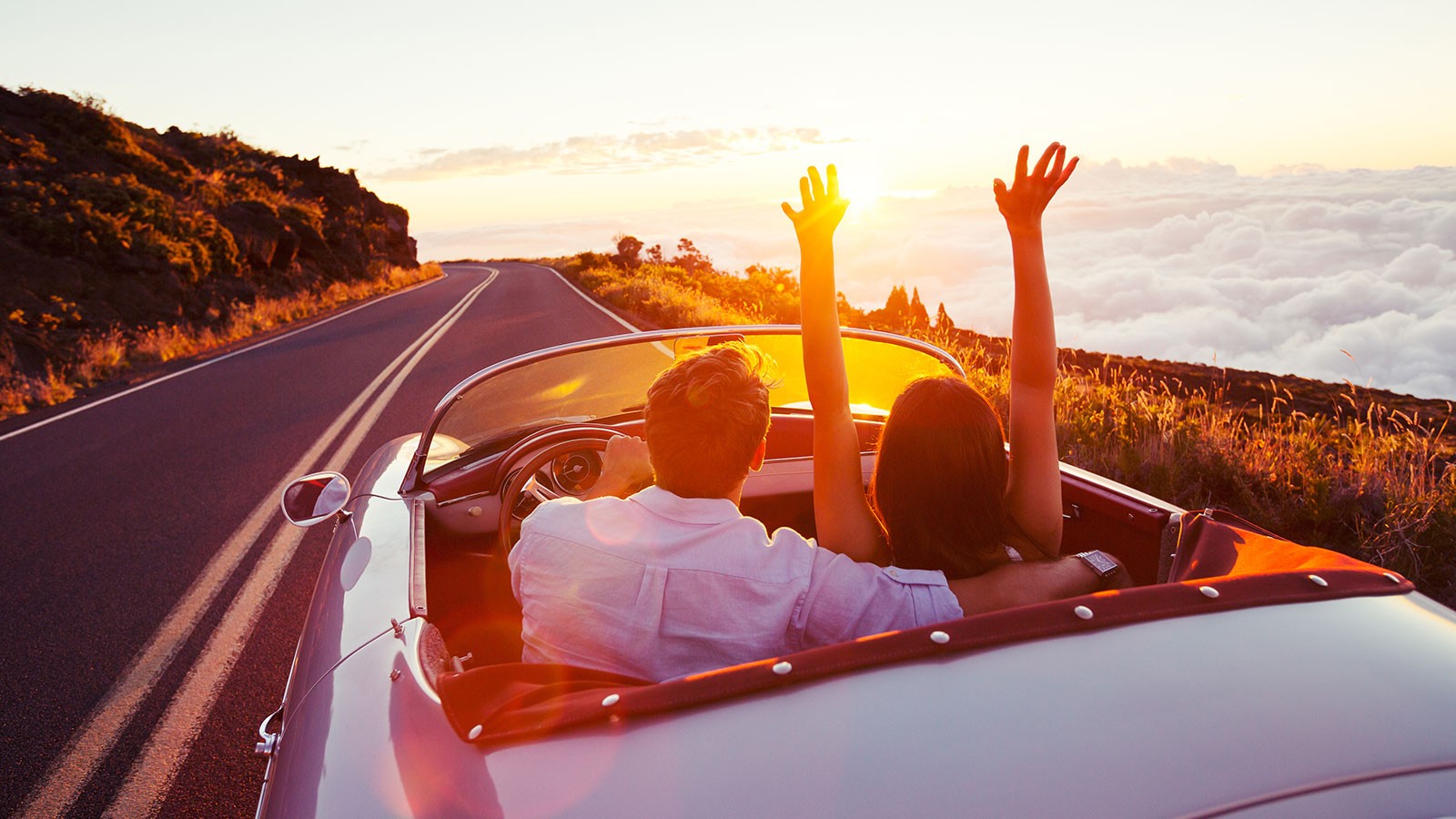 couple driving in a convertible.