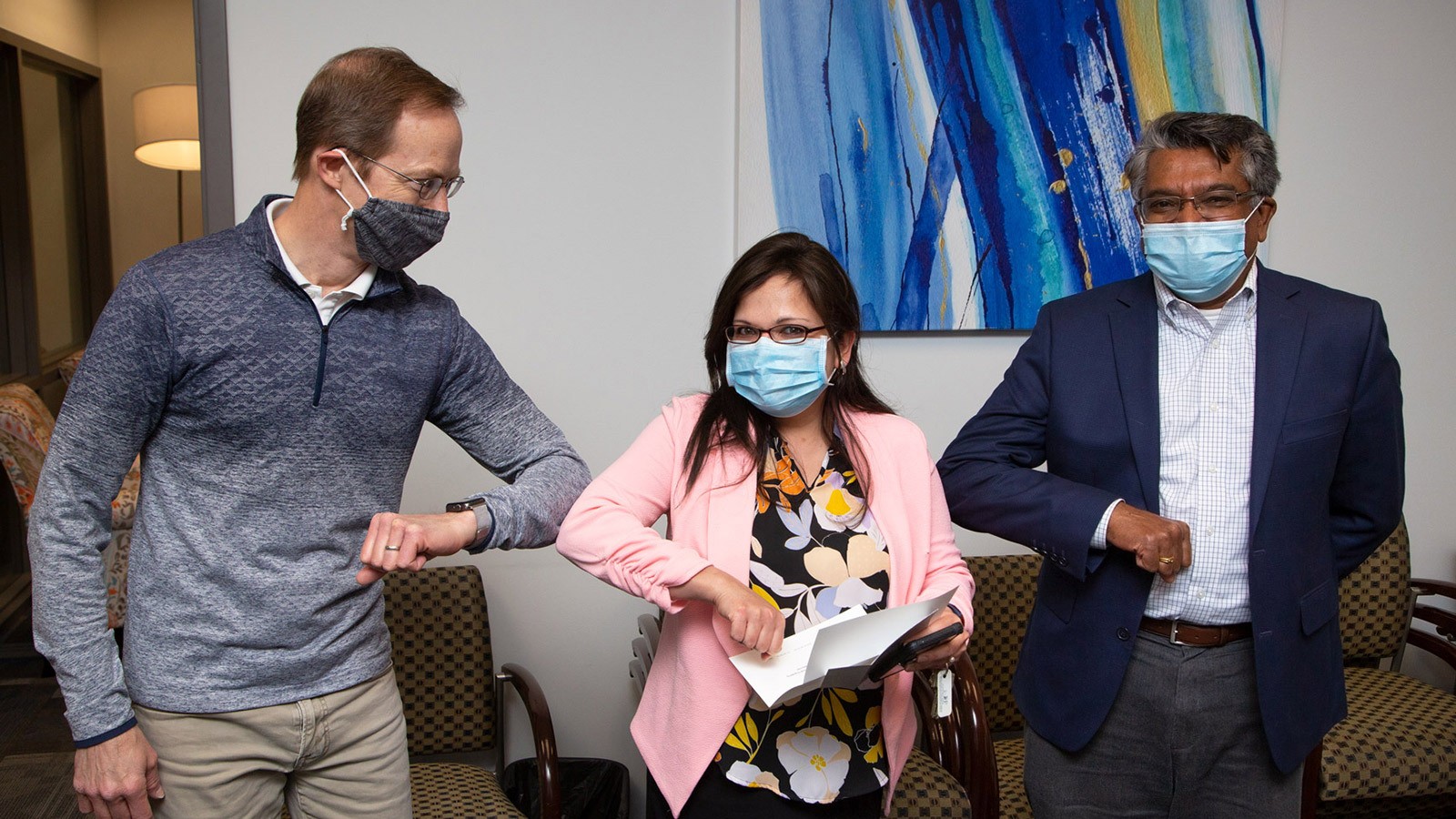 Sanghamitra Roy celebrates her promotion with Jake Gunther (left) and Dean Jagath Kaluarachchi.