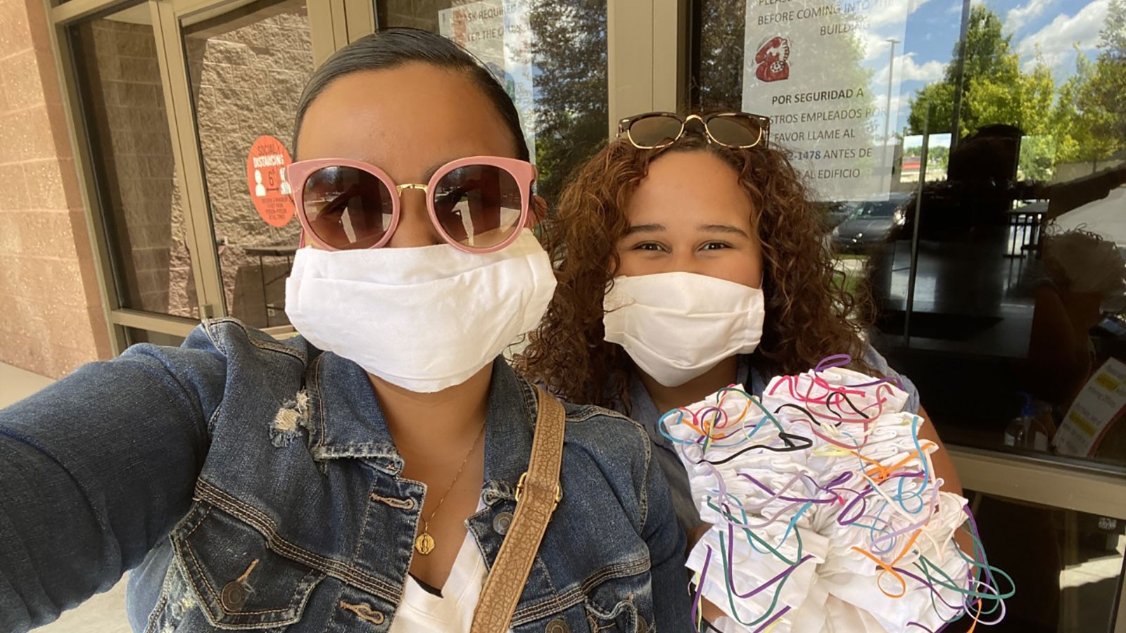 two women delivering masks to those in need.