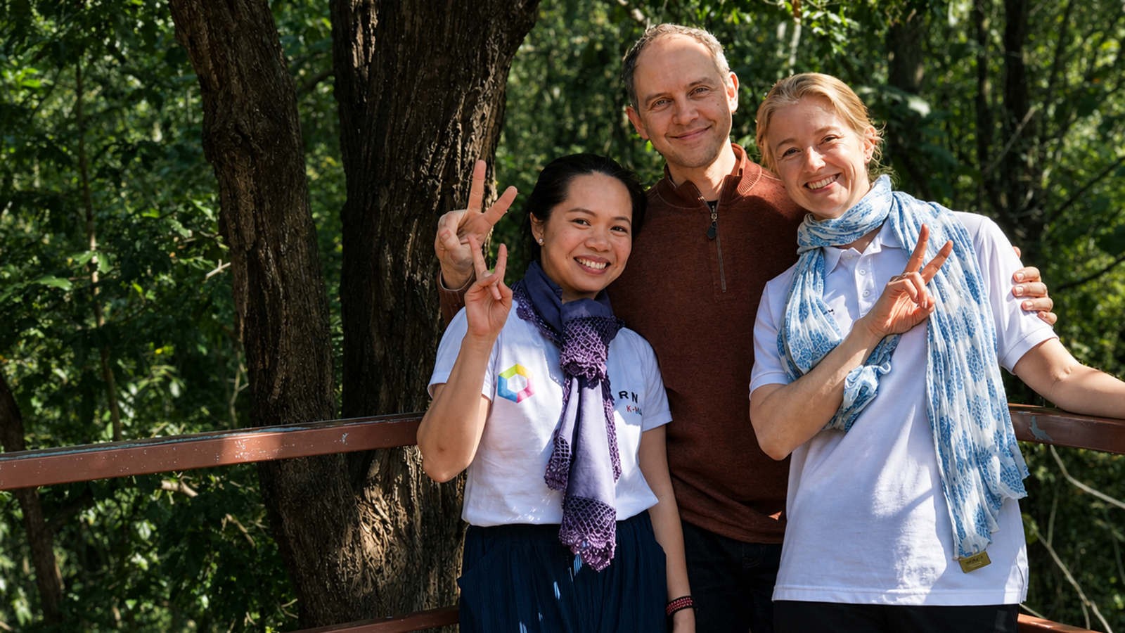 People posing for a photo outdoors.