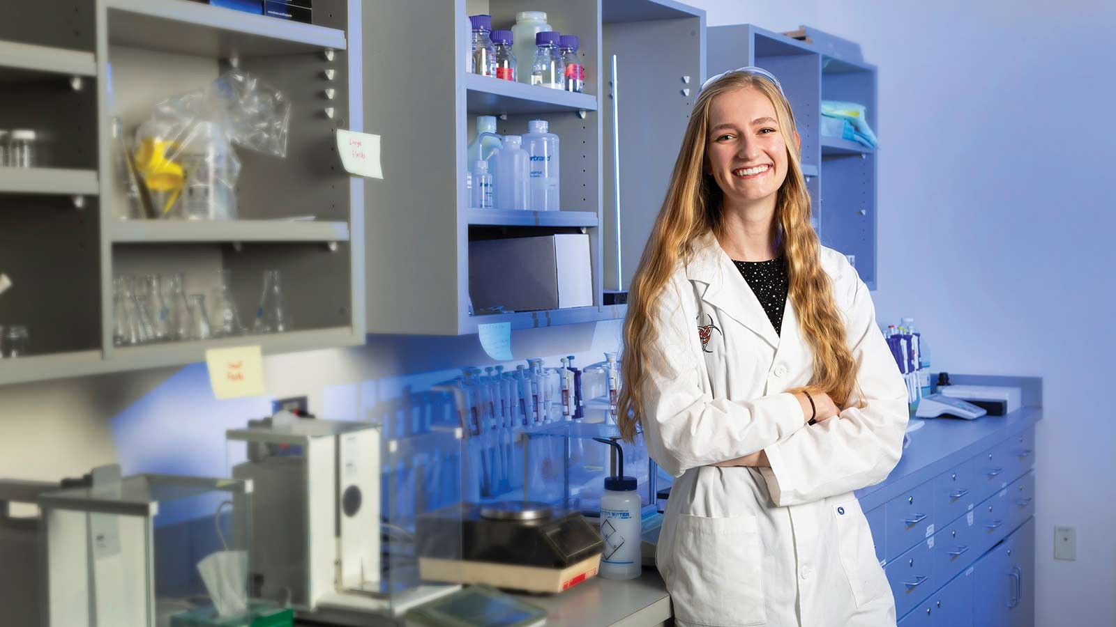 Kristine Peterson poses in a laboratory.