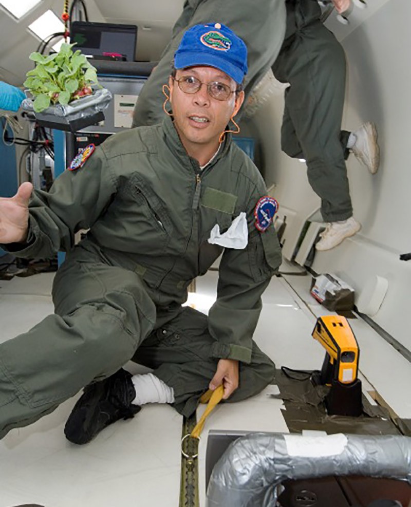 USU alumnus Oscar Monje-Mejia floats in a spacecract.