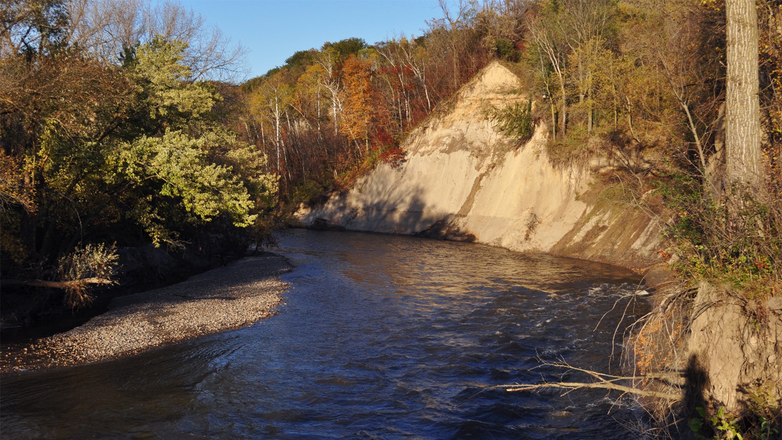 Riverbank eroded by high stream flows.