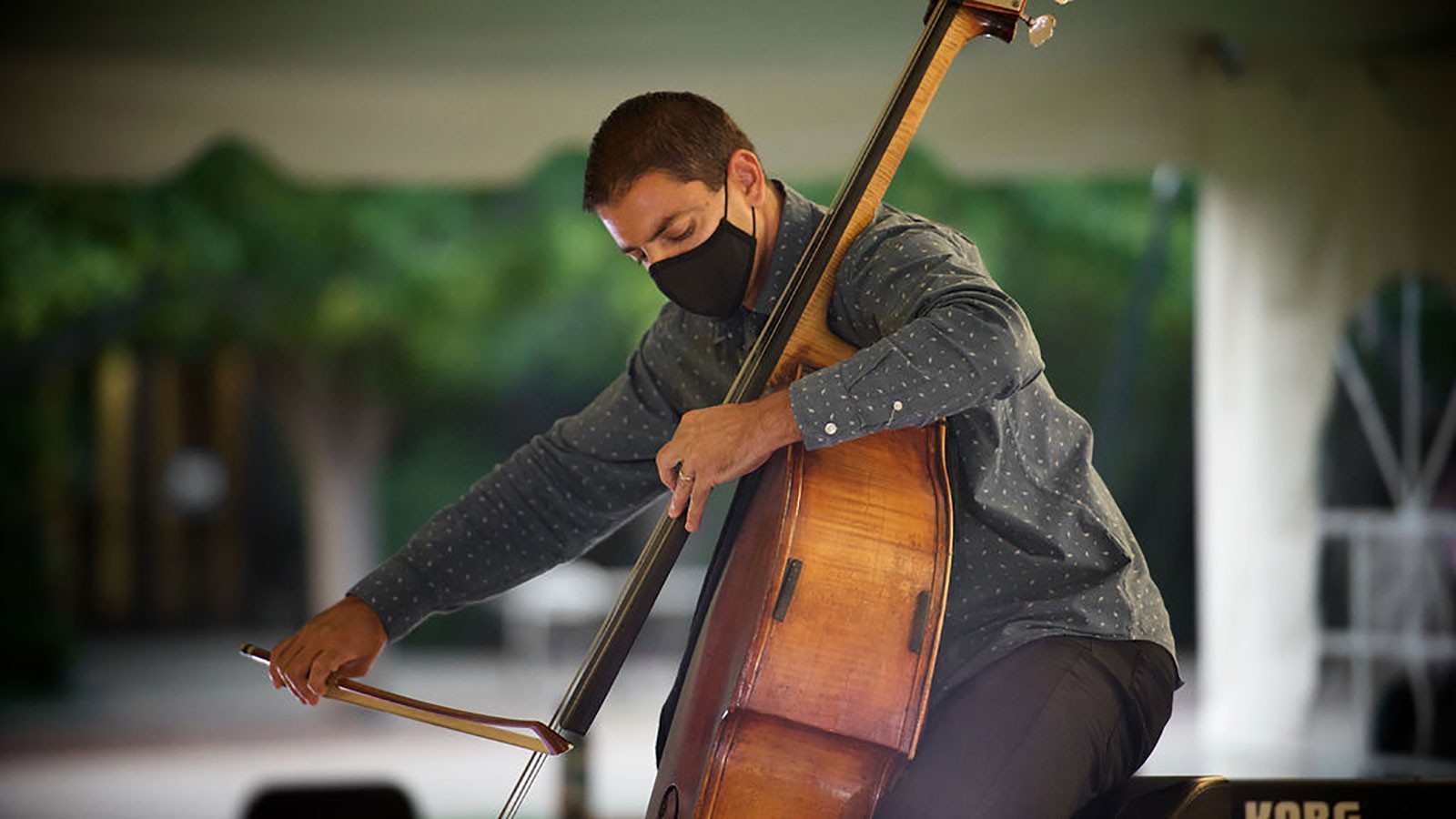 USU assistant professor of string and bass, Braun Khan, performing in the tent.