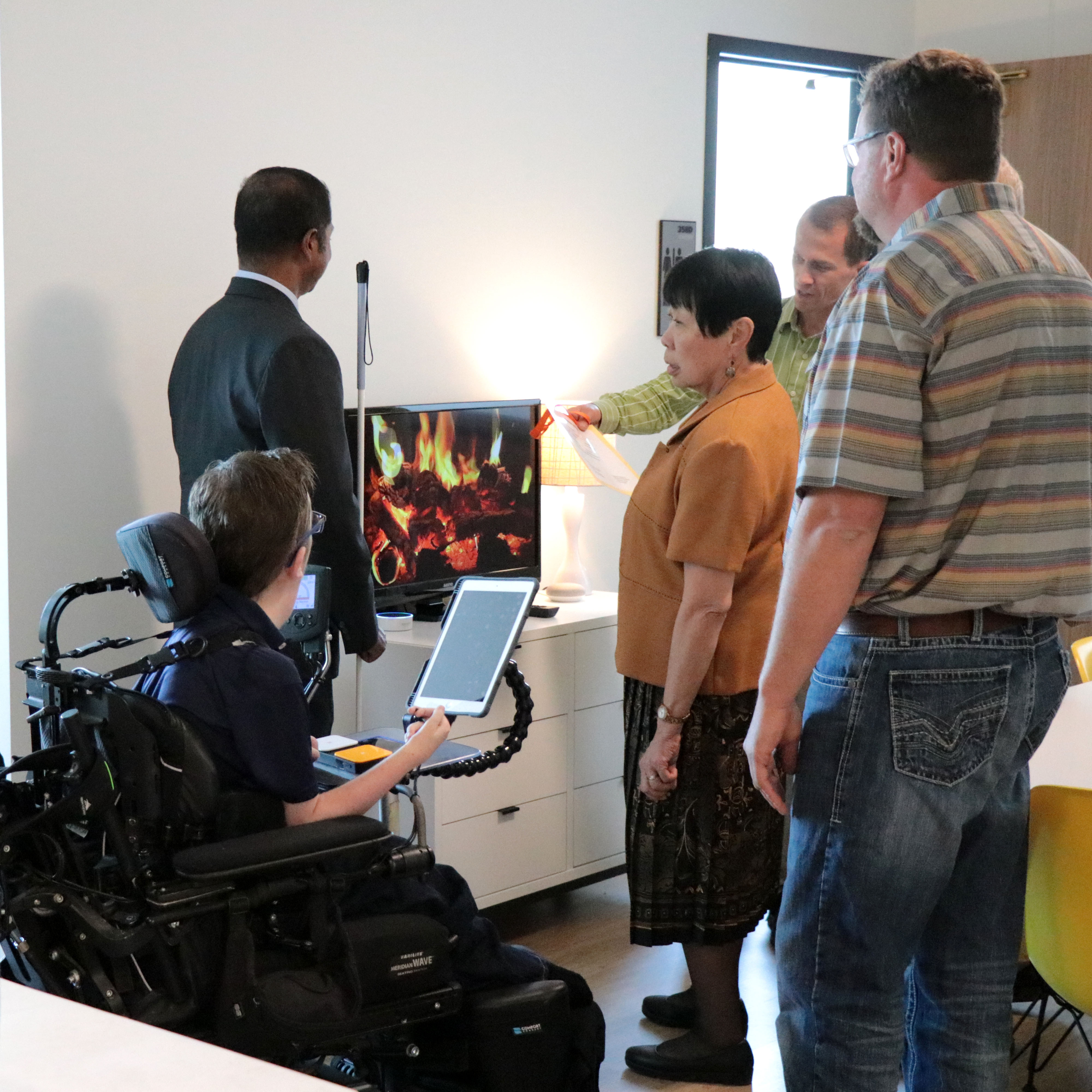 a small group tours the smart apartment