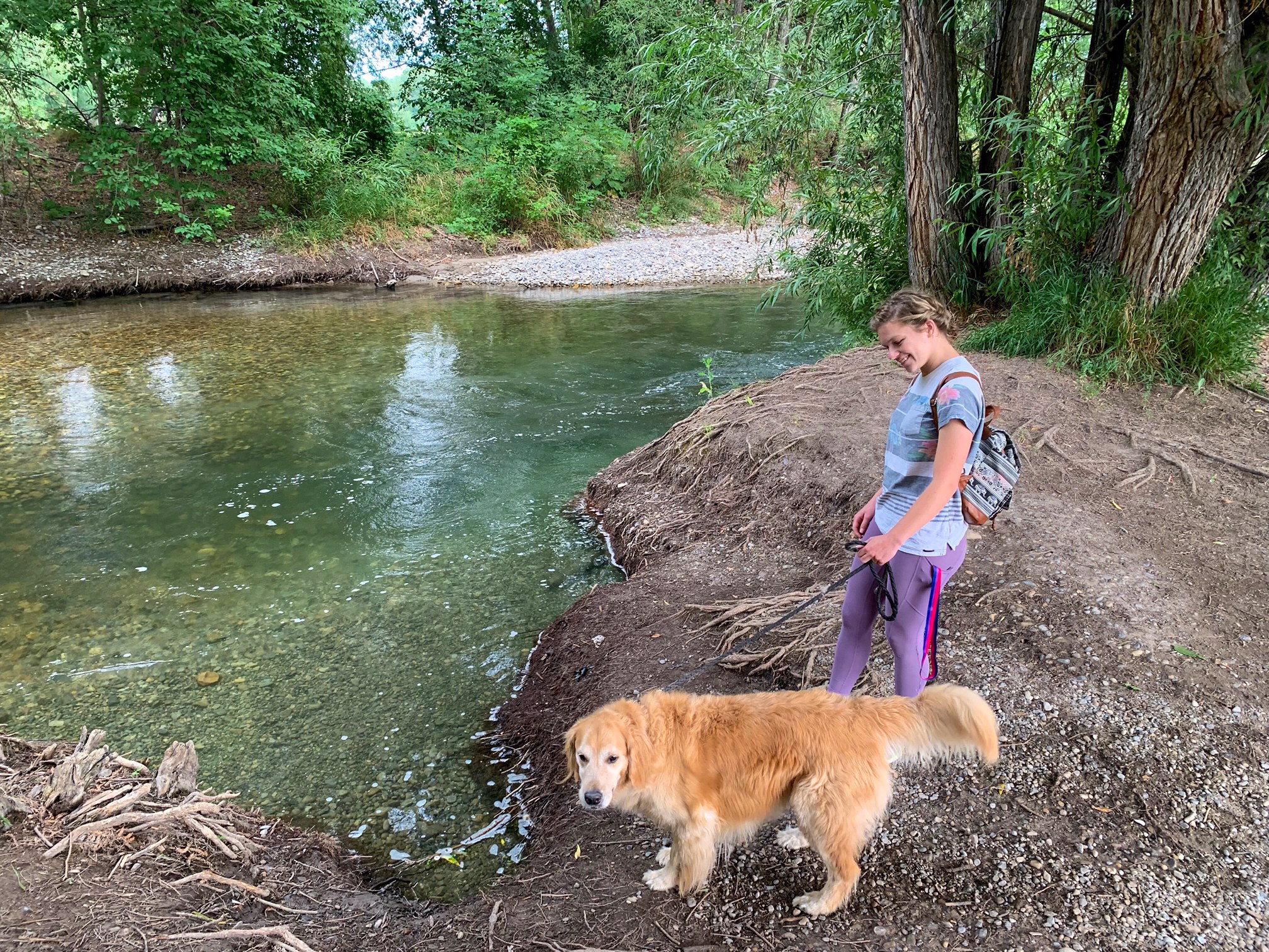 lady walking dog by Logan river
