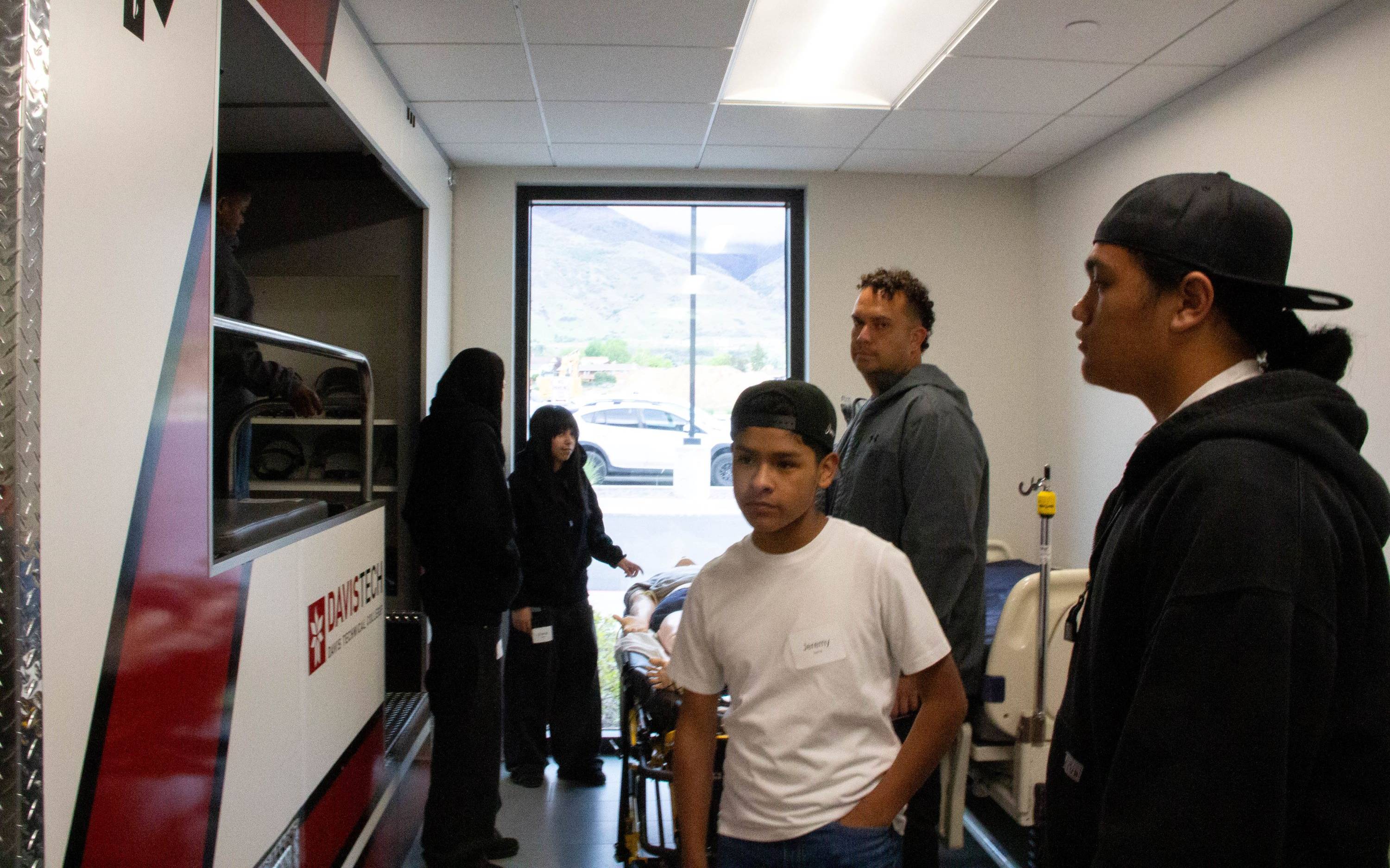 a group at Davis Technical College looking at a display