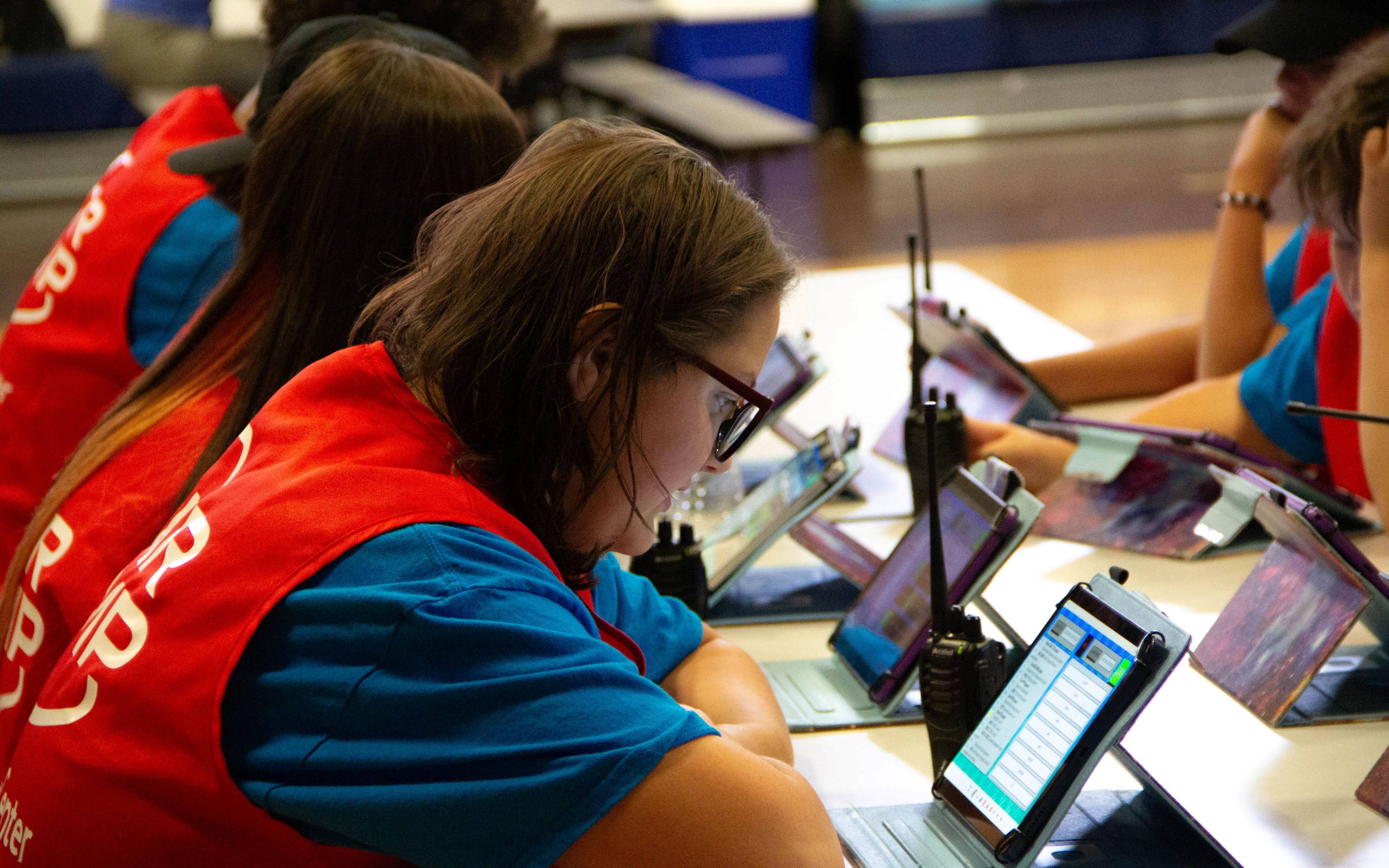 students at a table working with tablet technology simulating space missions