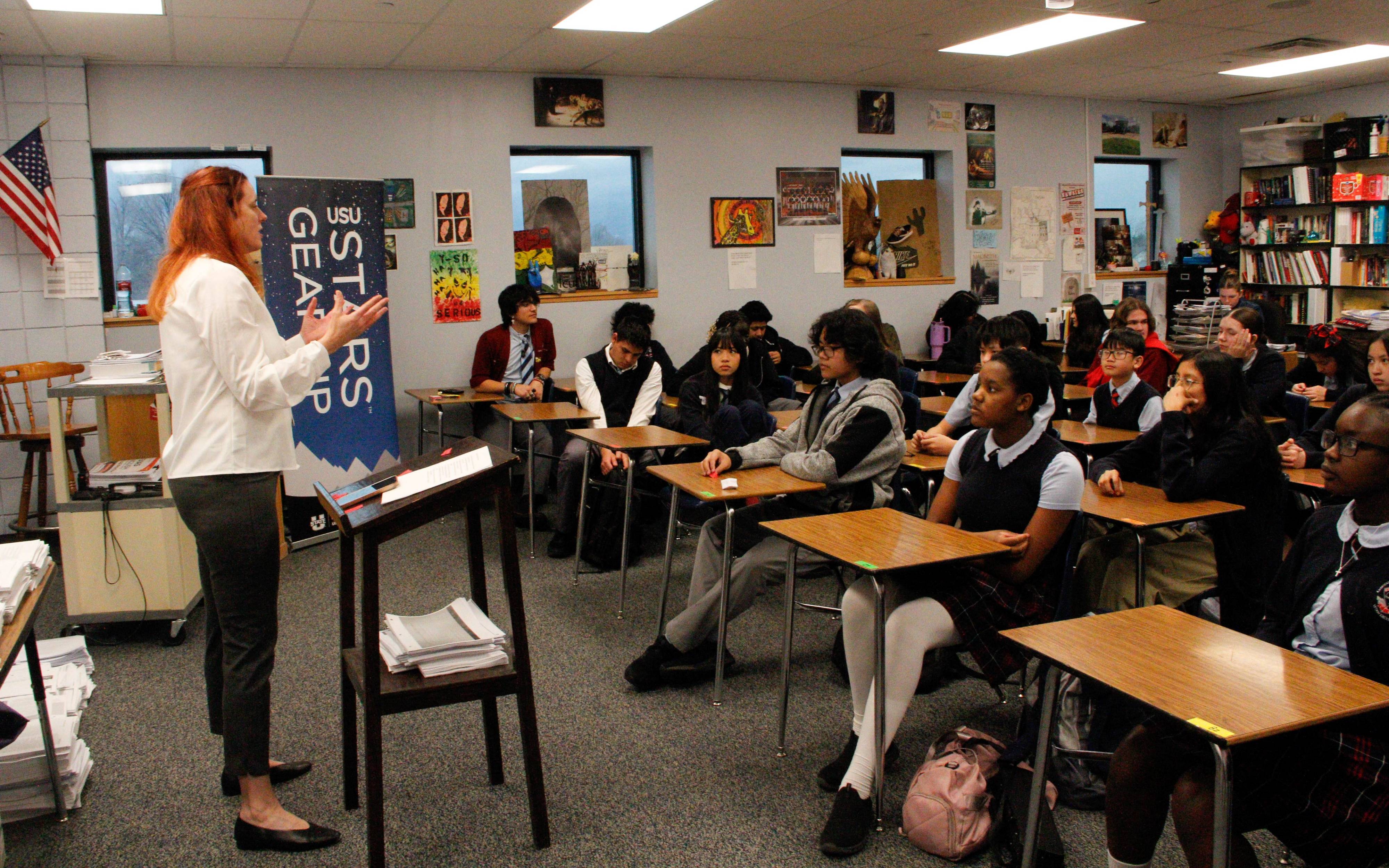 teacher standing in front of classroom of students