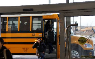 students exiting their bus at the event