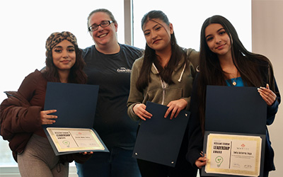 Students holding certificates.