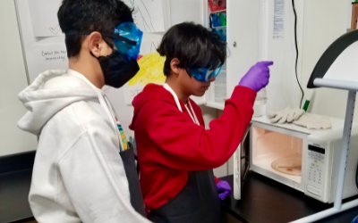 Two students working in a lab on campus.
