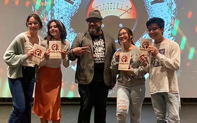 Students posing with Carlos.