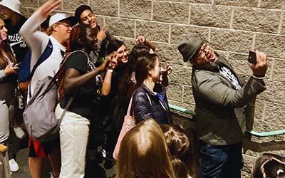 Students taking selfies with Carlos.