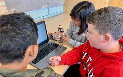 Students learn to program in Scratch at a week-long summer camp.
