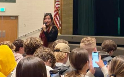 Rubi Franco Herrera speaking to a group of GEAR UP students.