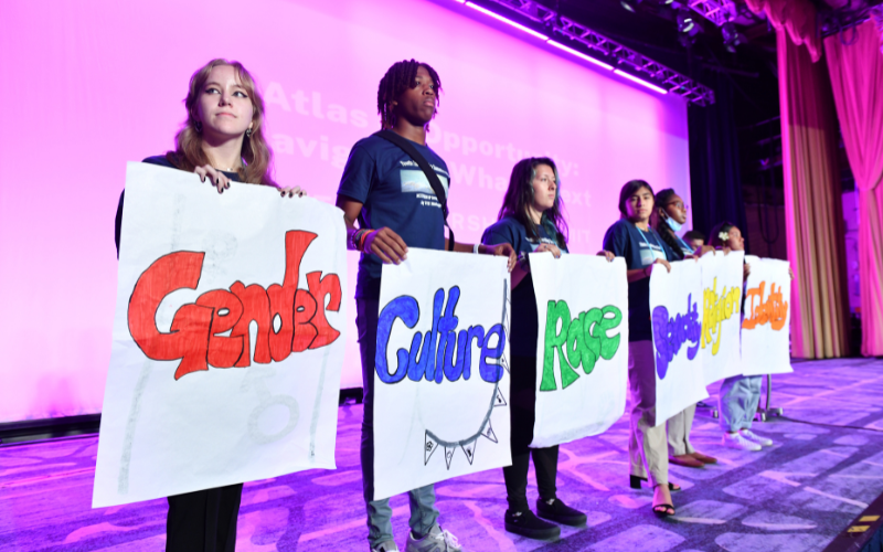 Students presenting on stage.