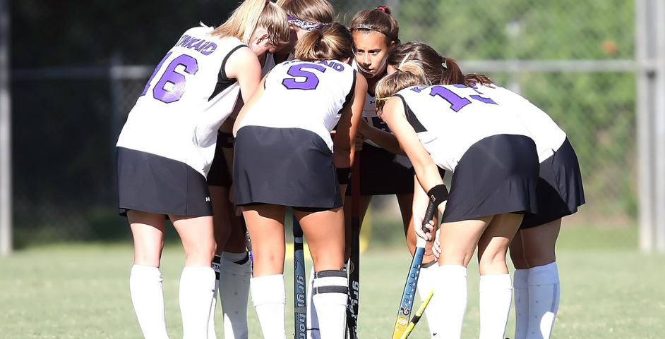 young girls playing sports in a huddle