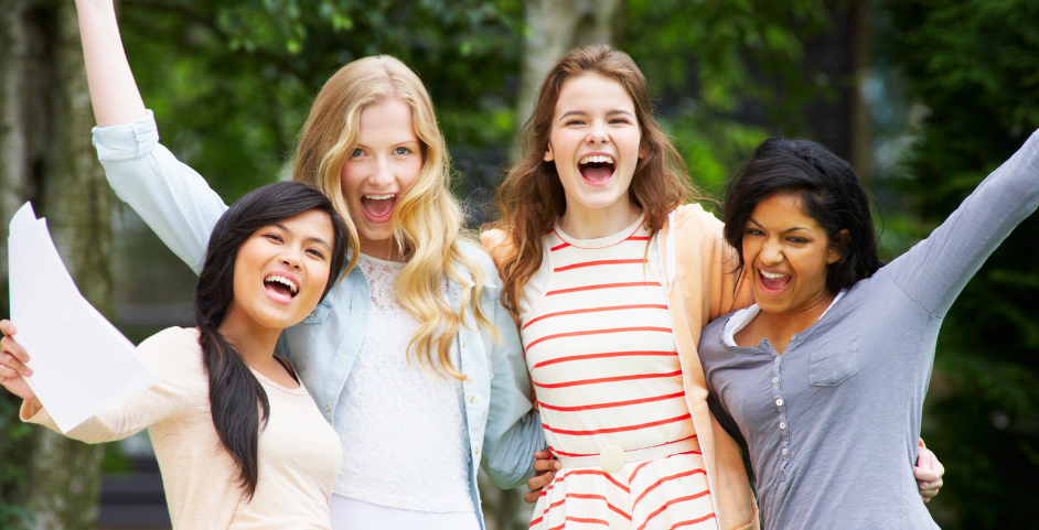 young girls with their arms around each other excited 