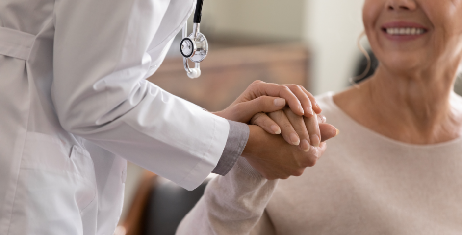 older woman holding a doctor's hand